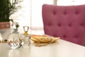 Elegant dressing table with perfume bottles and pink chair