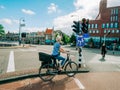 Elegant Dutch woman riding a Bike green light