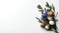Elegant Easter Arrangement with Speckled Eggs, Blue Flowers, and Greenery on White Royalty Free Stock Photo