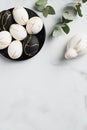 Elegant Easter flat lay composition. Luxury Easter eggs, bunny rabbit, eucalyptus leaves on marble table