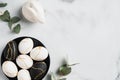 Elegant Easter flatlay composition. Luxury Easter eggs decorated with gold rabbit bunny eucalyptus leaves on marble table.