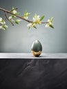 Elegant Easter interior decoration with an ornate egg and a blooming jasmine branch. Generative AI