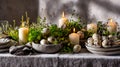 Elegant Easter setup with speckled eggs, greenery, and candles on a rustic table Royalty Free Stock Photo