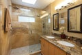 elegant eco-friendly bathroom with dual shower heads and natural stone tile