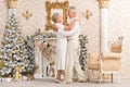 Portrait of a cute happy olderly couple dancing near christmas tree