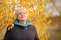 Elegant elderly woman portrait, autumn day. Royalty Free Stock Photo