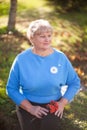 Elegant elderly woman portrait, autumn day. Royalty Free Stock Photo