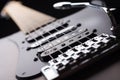 Elegant electric guitar on black background close up point of view from bridge