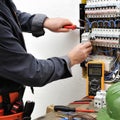 Elegant electrician technician at work on a residential electric Royalty Free Stock Photo