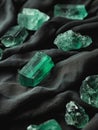 Elegant Emerald Crystals on Dark Fabric