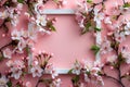 Elegant  an empty picture frame surrounded delicate cherry blossoms on a pink background, creating an elegant and springlike Royalty Free Stock Photo