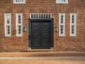 Elegant entrance front door with two windows