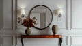 An elegant entryway console table with an orange glass top, adorned with a large mirror Royalty Free Stock Photo