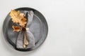 Elegant fall table setting with grey plate, autumn decor on white table. Top view. Space for text Royalty Free Stock Photo