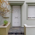 An elegant family urban house entrance with a white door. Royalty Free Stock Photo