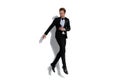 Elegant fashion businessman jumping with style in the air