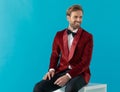 Elegant fashion man smiling and wearing red velvet tuxedo Royalty Free Stock Photo