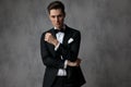 Elegant fashion man wearing black tuxedo on grey background Royalty Free Stock Photo