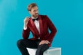 Elegant fashion man wearing red velvet tuxedo and looking to side Royalty Free Stock Photo