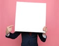 Elegant fashion model hiding behind white empty board