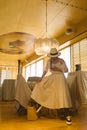 Elegant fashionable woman wearing summer white dress, straw hat, posing in stylish boho interior. Royalty Free Stock Photo