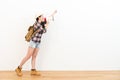 Elegant female backpacker standing on wooden floor