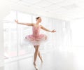 Elegant female ballet dancer in pink tutu practicing and smiling Royalty Free Stock Photo