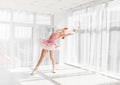 Elegant female ballet dancer in pink tutu practicing and smiling Royalty Free Stock Photo