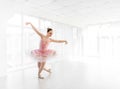 Elegant female ballet dancer in pink tutu practicing and smiling Royalty Free Stock Photo