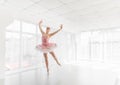 Elegant female ballet dancer in pink tutu practicing and smiling Royalty Free Stock Photo