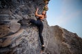 Elegant female extreme climber looking in camera