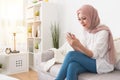 Elegant female muslim using mobile smartphone