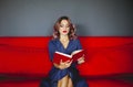 Woman reading book on couch