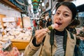 An elegant female traveler eating Dango Royalty Free Stock Photo