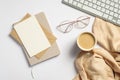 Elegant feminine workspace with pc keyboard, glasses, beige plaid, glasses, blank paper card, envelope, notebook on white