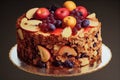 Elegant festive fruit cake with candied fruits and pieces of dried berries