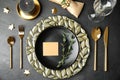 Elegant festive table setting with blank card on background, flat lay