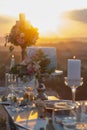 Elegant festive table setting with colorful flowers, cutlery, candles, cake Royalty Free Stock Photo