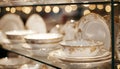 Elegant Fine China Display with Intricate Patterns in Store Window. Concept of decorative dinnerware, Luxury Dining Royalty Free Stock Photo