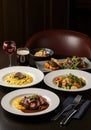 Elegant Fine Dining Meal: Steak, Risotto, Seafood, and Salad Royalty Free Stock Photo