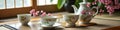Elegant floral teacups and teapot with cherry blossoms on wooden table Royalty Free Stock Photo