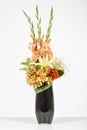 Elegant flower arrangement in beautiful vase isolated in a bright white studio