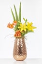 Elegant flower arrangement in beautiful vase isolated in a bright white studio