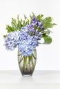 Elegant flower arrangement in beautiful vase isolated in a bright white studio