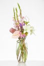 Elegant flower arrangement in beautiful vase isolated in a bright white studio