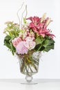 Elegant flower arrangement in beautiful vase isolated in a bright white studio