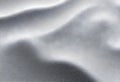 elegant folded silver fabric texture with smooth silky surface and soft light reflections Royalty Free Stock Photo