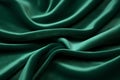 Elegant folds of a smooth deep green satin velvet fabric create an intricate play of shadows and highlights