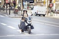 elegant French girl on a moped on street