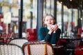 Elegant French woman in Parisian cafe Royalty Free Stock Photo